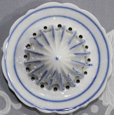 The reamer for a blue on white ceramic German juicer with offset loop handle