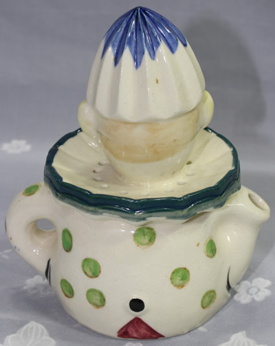 The green polka dots on the back of a white crossed eyes clown juicer