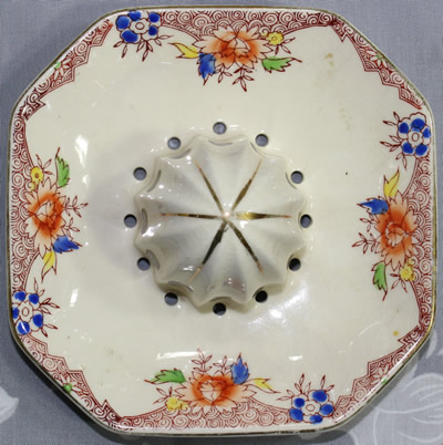 The reamer for a brown, blue and yellow flowers on an octagonal shape juicer