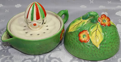 An open green with red flowers and yellow leaves clown 3 piece juicer