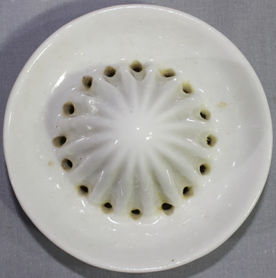 Reamer for a red with green leaves ceramic juicer