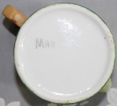 The signed base of a mushrooms hand painted on a ceramic 2 piece juicer