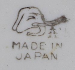 The basemark on silver leaves on pale yellow lustre pear shape juicer