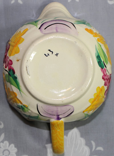 Base of a Sylvan Ware juicer with mauve and yellow flowers juicer