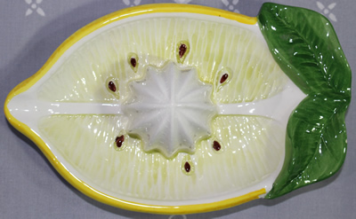 Top view of small sliced lemon ceramic juicer