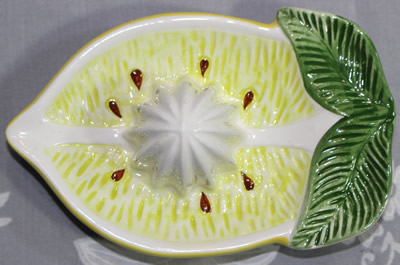 Top view of small sliced lemon ceramic juicer