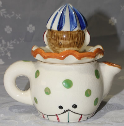 Back view of crossed eyes clown with striped pants blue hat juicer
