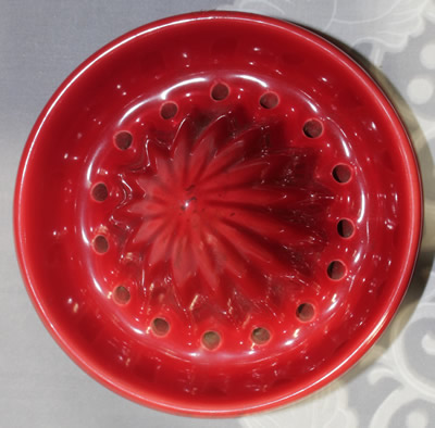 The reamer for a 2 piece cherry red ceramic jug juicer