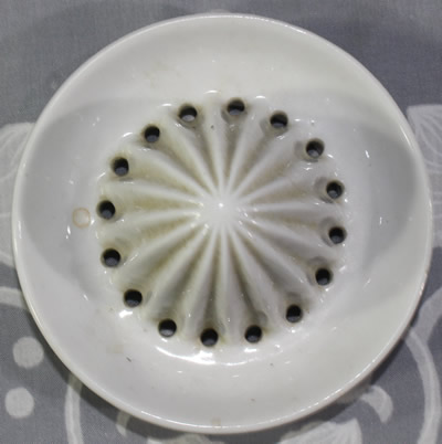 The reamer for a teapot shape red dark orange peel texture with white reamer juicer