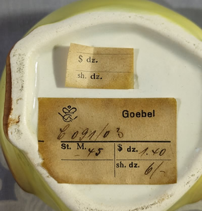 Goebel museum tag for a yellow chicken juicer with maroon trim