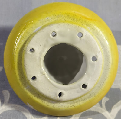 Bottom view of the reamer for a two piece light brown face shape juicer set