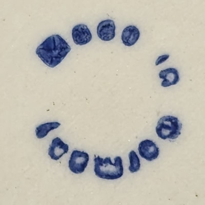 Pottery mark on a flesh colour and blue child juicer