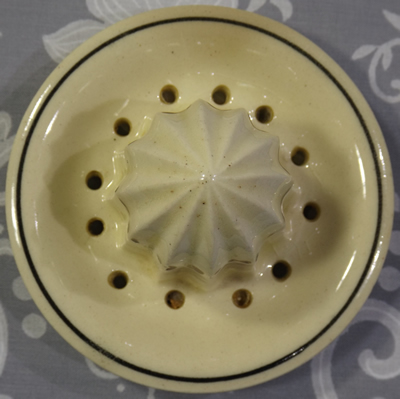 Cream & black with maroon flowers ceramic reamer