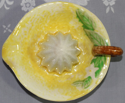 Top view of yellow & white with green leaves ceramic juicer
