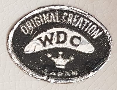 Foil WDC label on a yellow smiley face juicer