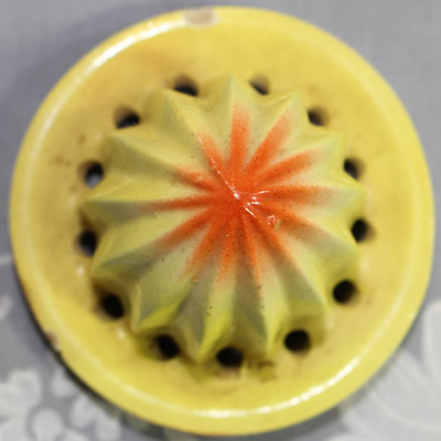 The yellow for an orange ceramic Baby's Orange juicer