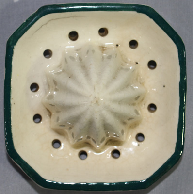 Reamer for a yellow fruit and blue flowers on ceramic juicer