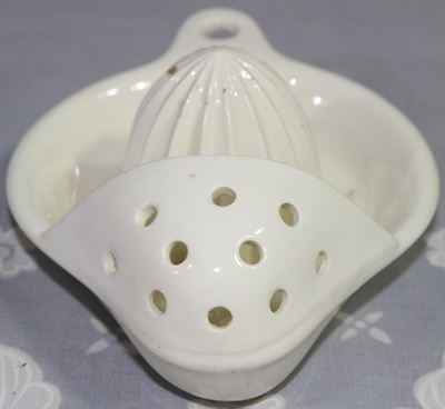 Front view of a white German ceramic strainer juicer