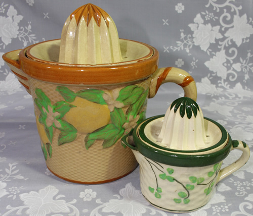 Very large lemons & leaves on ceramic juicer next to more common size