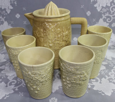 The set of a cream embossed with flowers and leaves jug juicer and tumblers 