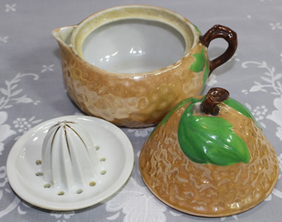 he 3 parts of a light brown lustre pear shape ceramic juicer