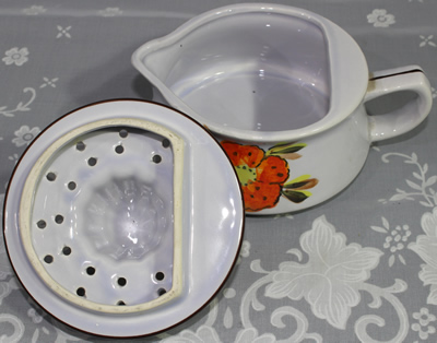 Two parts of orange flower on blue lustre white & black ceramic juicer