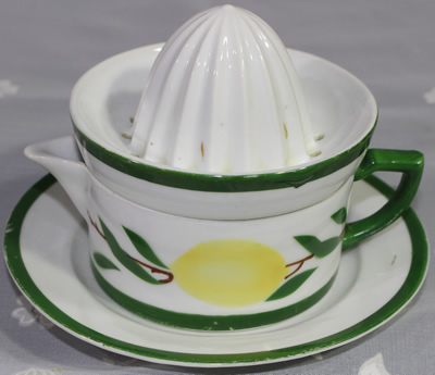 White, lemons and green trim 2 piece juicer on matching saucer