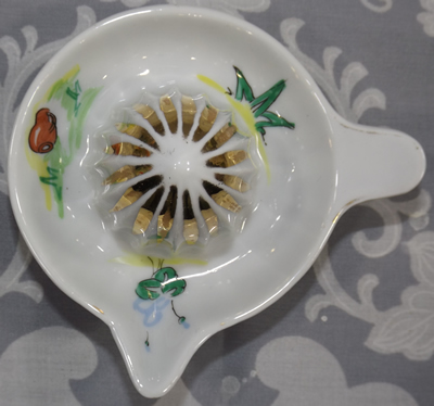 Top view of a small hand painted gold trim ceramic juicer