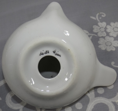 Bottom view of a small hand painted gold trim ceramic juicer