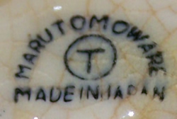 The Marutomo Ware basemark on a cream and green bee juicer 