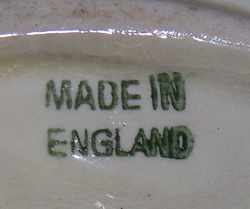 The basemark on a yellow, orange, black and green English saucer juicer