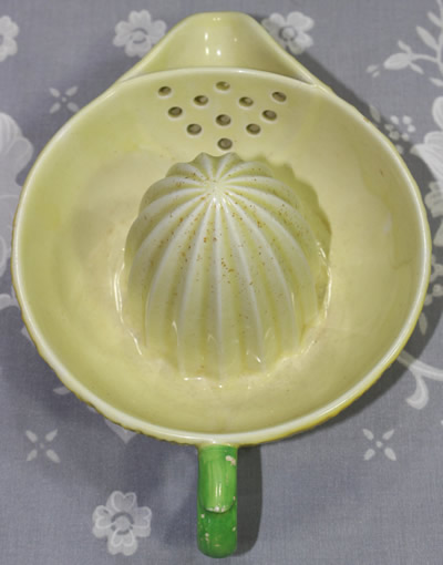 Top view of a large yellow Carlton Ware 1 piece 'peel' juicer