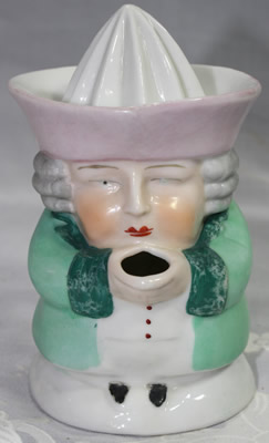 Front of a pale green with pink hat 1 piece toby juicer