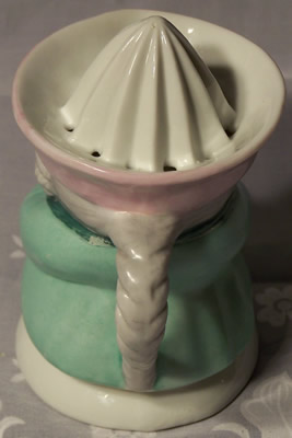 Back of a pale green with pink hat 1 piece toby juicer