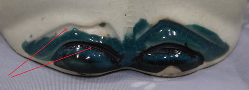 Extra detail for feet on a dark green and maroon 5⅝" clown juicer