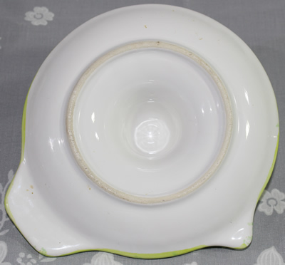 Base of a mottled green and yellow saucer juicer