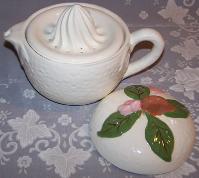 An open large 3 piece covered white juicer