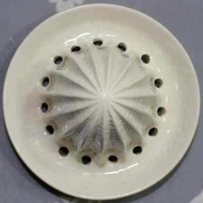 The 2 parts of a Carlton Ware grapefruit plate with juicer