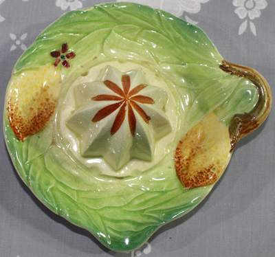 Top view of Lemons on green, cream & brown ceramic saucer juicer