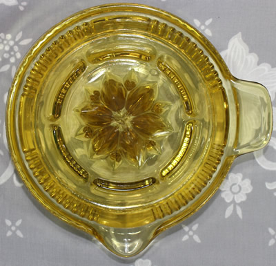 Top view of Federal Glass Co. amber saucer shape juicer