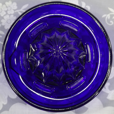 Reamer for Cobalt blue glass juicer embossed with a lemon and an orange