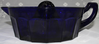Side view of a vobalt blue reproduction of Westmoreland Speciality Co. juicer