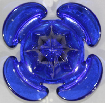 Top view of a cloverleaf shaped cobalt blue juicer