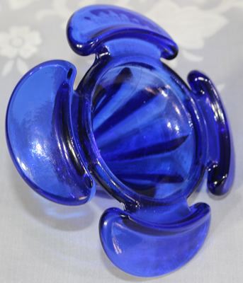 Possible writing on bottom of a cloverleaf shaped cobalt blue juicer 