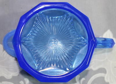 The base of the cup for a frosted blue glass Edna Barnes 2 piece juicer