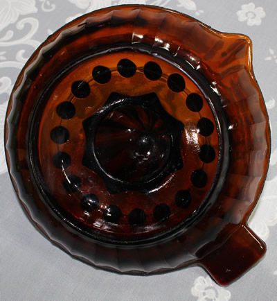 The base of a brown glass panelled juicer