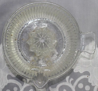 Top view showing the seed dam in a clear glass deep saucer juicer