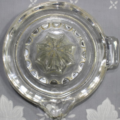 Top view of a flat pip collector U.S. Glass Company clear glass juicer