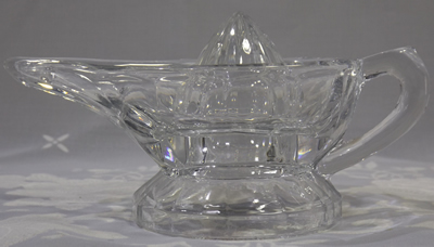 Profile of a small raised handle Alladin's lamp clear glass juicer