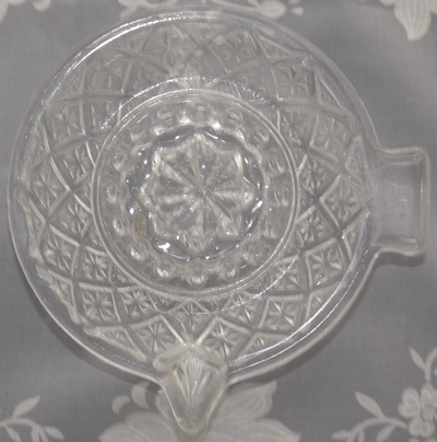 Top view of a clear glass juicer with diamond pattern